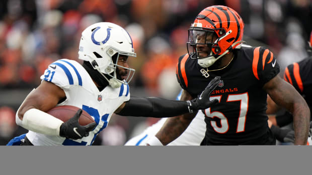 Dec. 10, 2023; Cincinnat, Ohio, USA; Indianapolis Colts running back Zack Moss (21) carries the ball as Cincinnati Bengals linebacker Germaine Pratt (57) defends in the first quarterat Paycor Stadium.